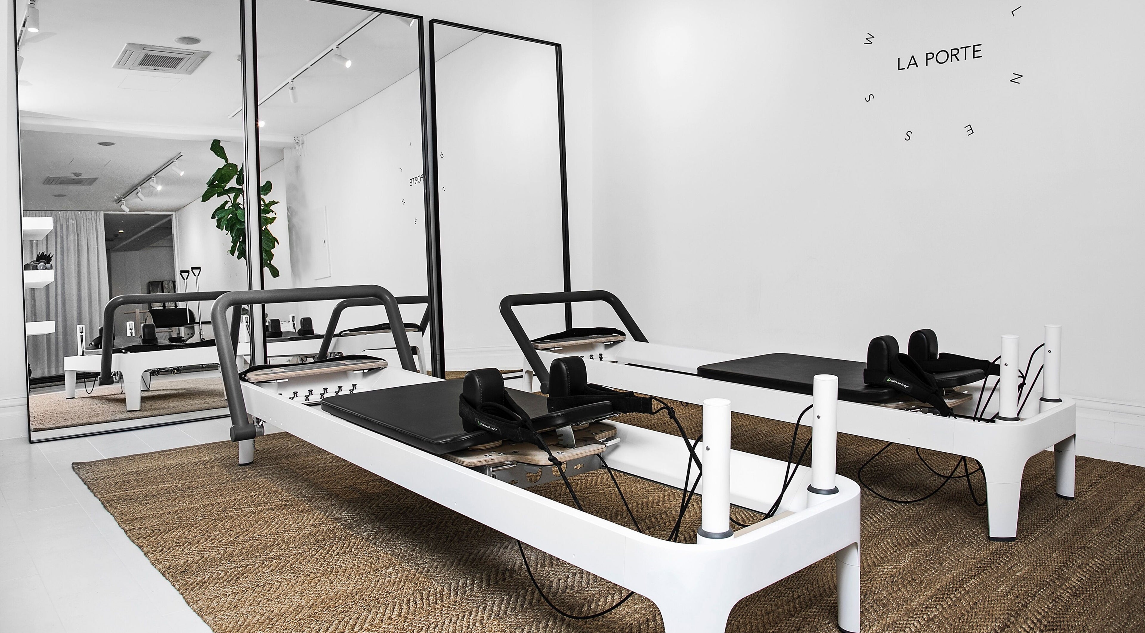 Modern Pilates studio at La Porte Wellness in Rosebery, New South Wales, AU with sleek reformer machines.