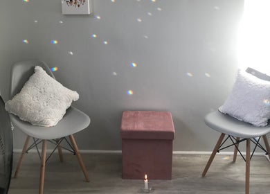Calm corner at Bali Rose Beauty Salon, Cape Town, Western Cape, ZA, featuring chairs and soft lighting.