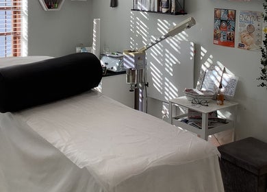 Relaxing spa room at Bali Rose Beauty Salon in Cape Town, Western Cape, ZA, with treatment bed and decor.