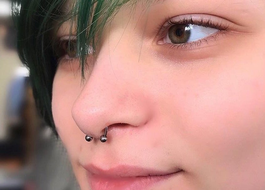Close-up of a stylish nose piercing at Samsara Studio, Folkestone, England, GB enhancing unique facial style.