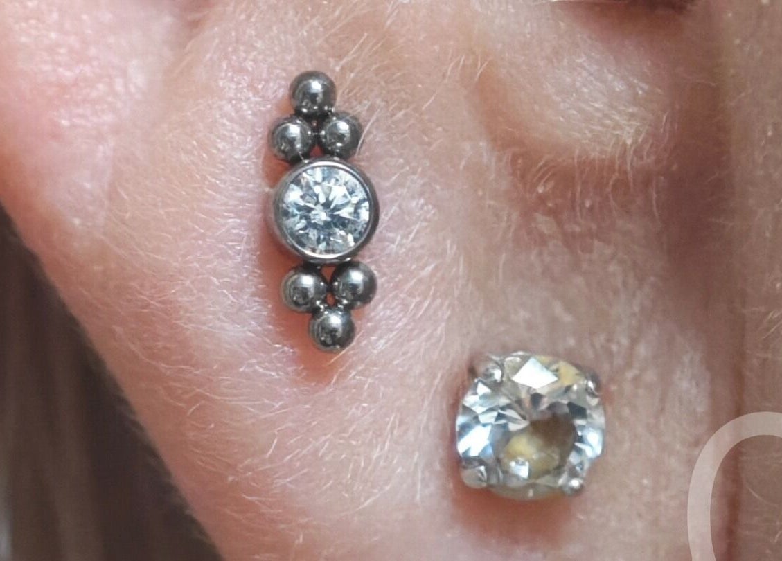 Close-up of elegant ear piercing with jewel design at Samsara Studio, Folkestone, England, GB.