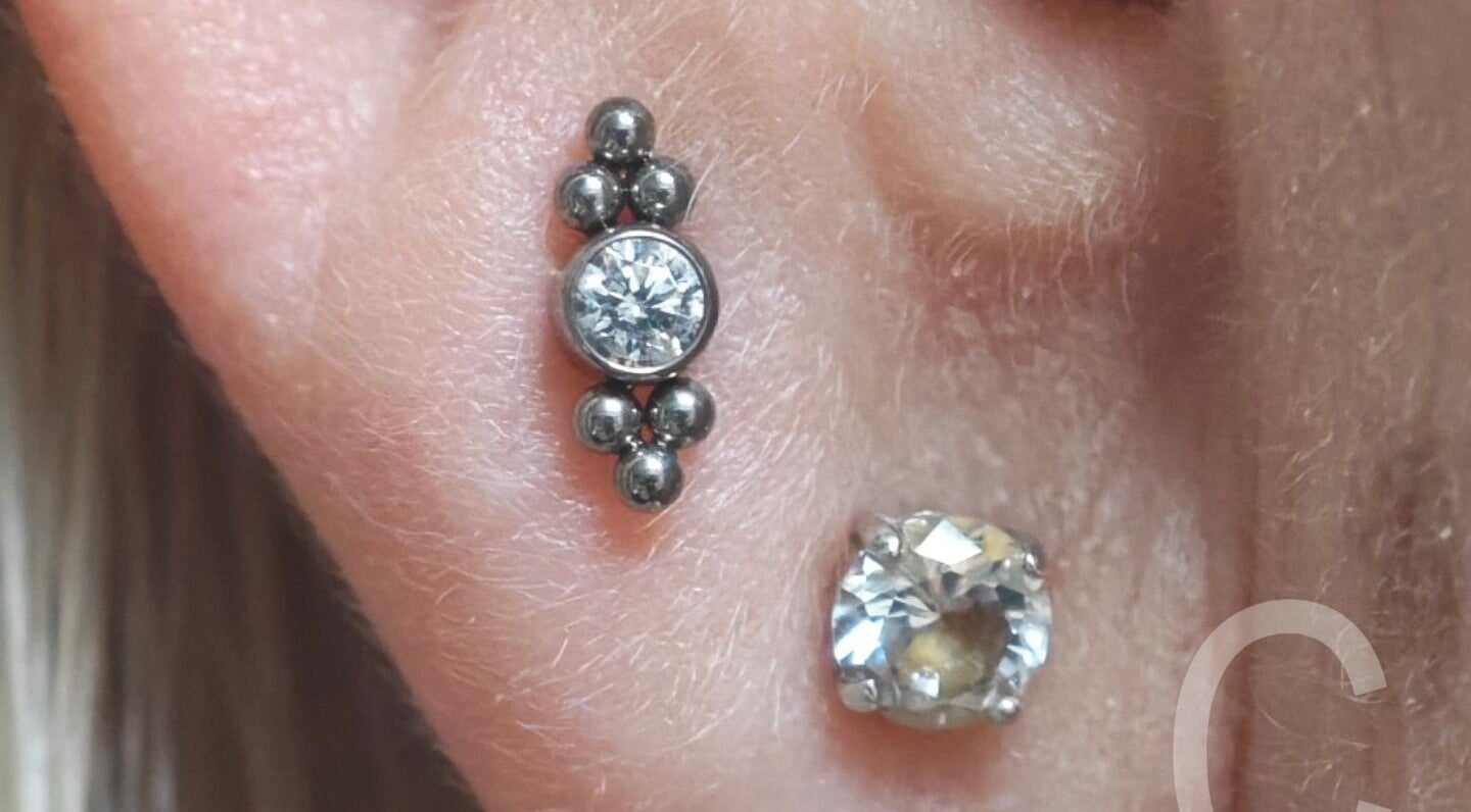 Close-up of elegant ear piercing with jewel design at Samsara Studio, Folkestone, England, GB.
