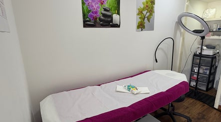 Cozy treatment room at Claudia's Hair And Beauty, Grays, England, GB, with a massage bed and calming decor.