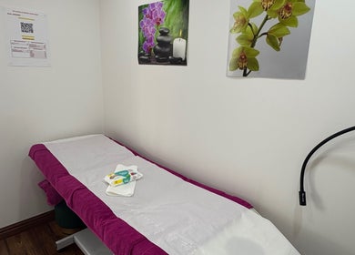 Relaxing spa room at Claudia's Hair And Beauty, Grays, England, GB with massage table and calming decor.