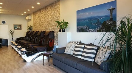 Relaxing lounge at Rio Beauty, Napier, Hawke's Bay, NZ, featuring plush chairs and tranquil decor.