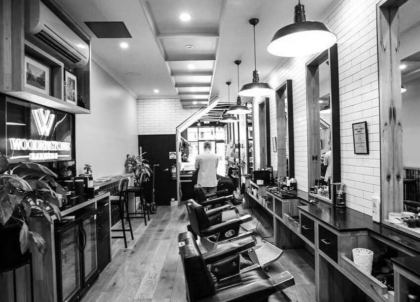 Elegant interior of Woodenstone Barbers, Byron Bay, New South Wales, AU with classic barber chairs and stylish decor.