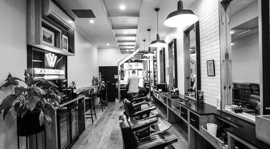 Elegant interior of Woodenstone Barbers, Byron Bay, New South Wales, AU with classic barber chairs and stylish decor.
