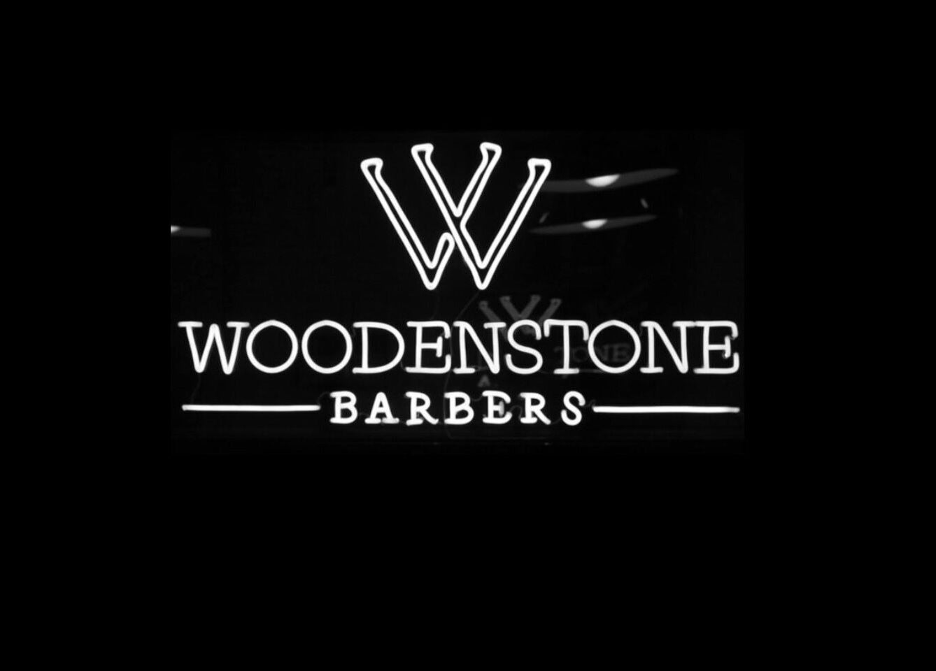 Illuminated Woodenstone Barbers sign at Byron Bay, New South Wales, AU.