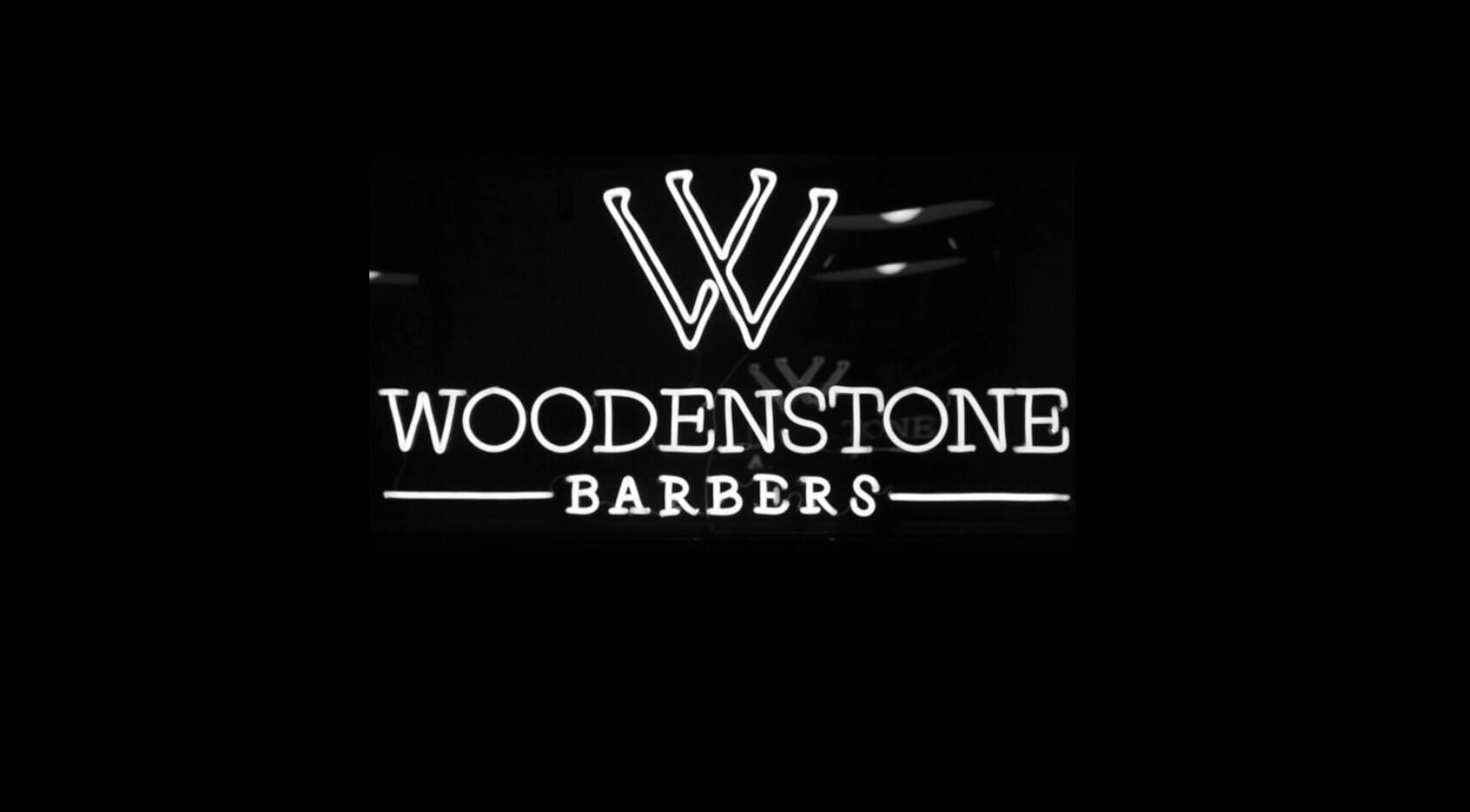 Illuminated Woodenstone Barbers sign at Byron Bay, New South Wales, AU.
