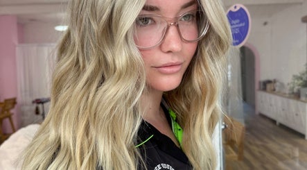 Stylish blonde wavy hairstyle at La Lars Hair in Maryborough, Queensland, AU.
