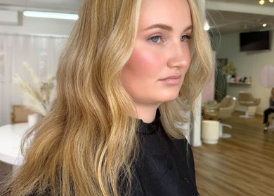 Client with golden hair at La Lars Hair, Maryborough, Queensland, AU. Elegant salon background enhances the scene.
