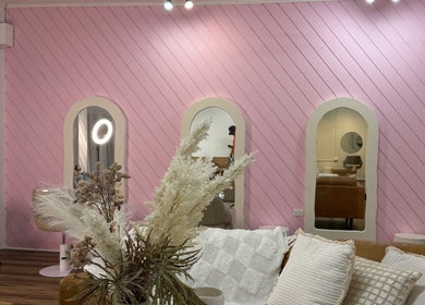 Elegant La Lars Hair salon in Maryborough, Queensland, AU with pink walls and mirrors.