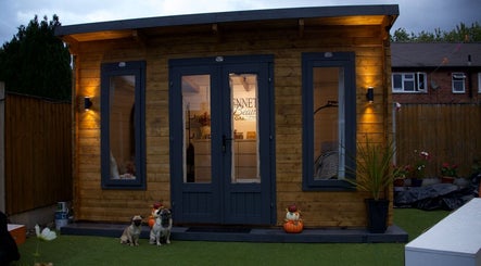 Cozy exterior of Bennett’s Beauty Garden in Warrington, England, GB with warm lighting and lush surroundings.