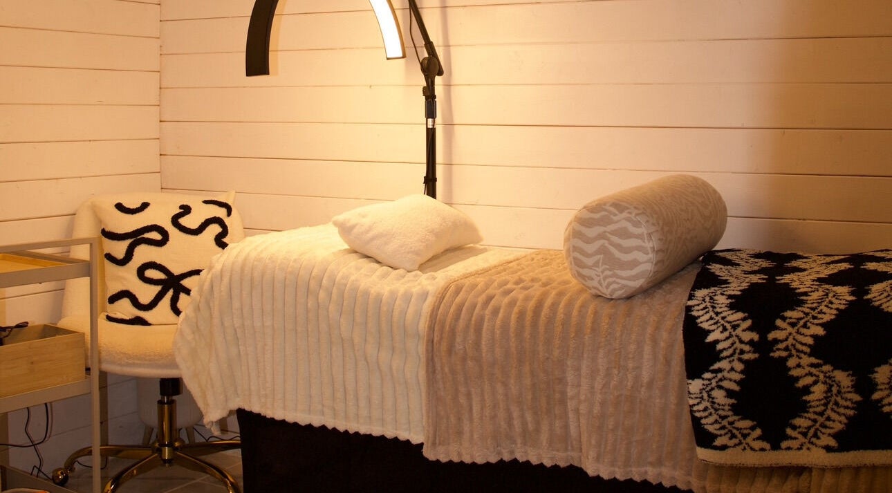 Peaceful treatment room at Bennett’s Beauty Garden, Warrington, England, GB with cozy bed setup.