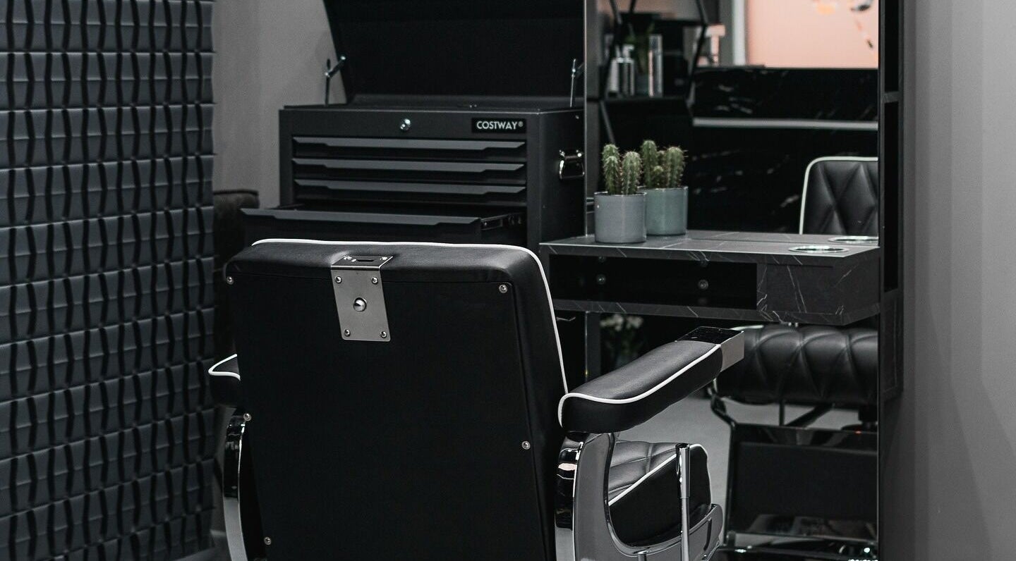 Chic barber chair and sleek decor at Collab Cuts, Lanark, Scotland, GB highlighting modern salon vibe.