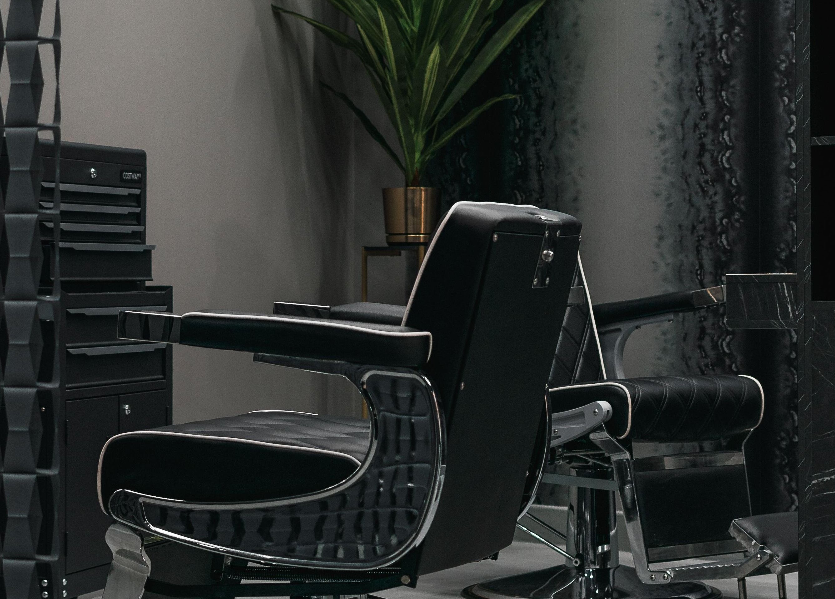 Luxurious barber chair at Collab Cuts, Lanark, Scotland, GB, set amid a sleek, modern interior.