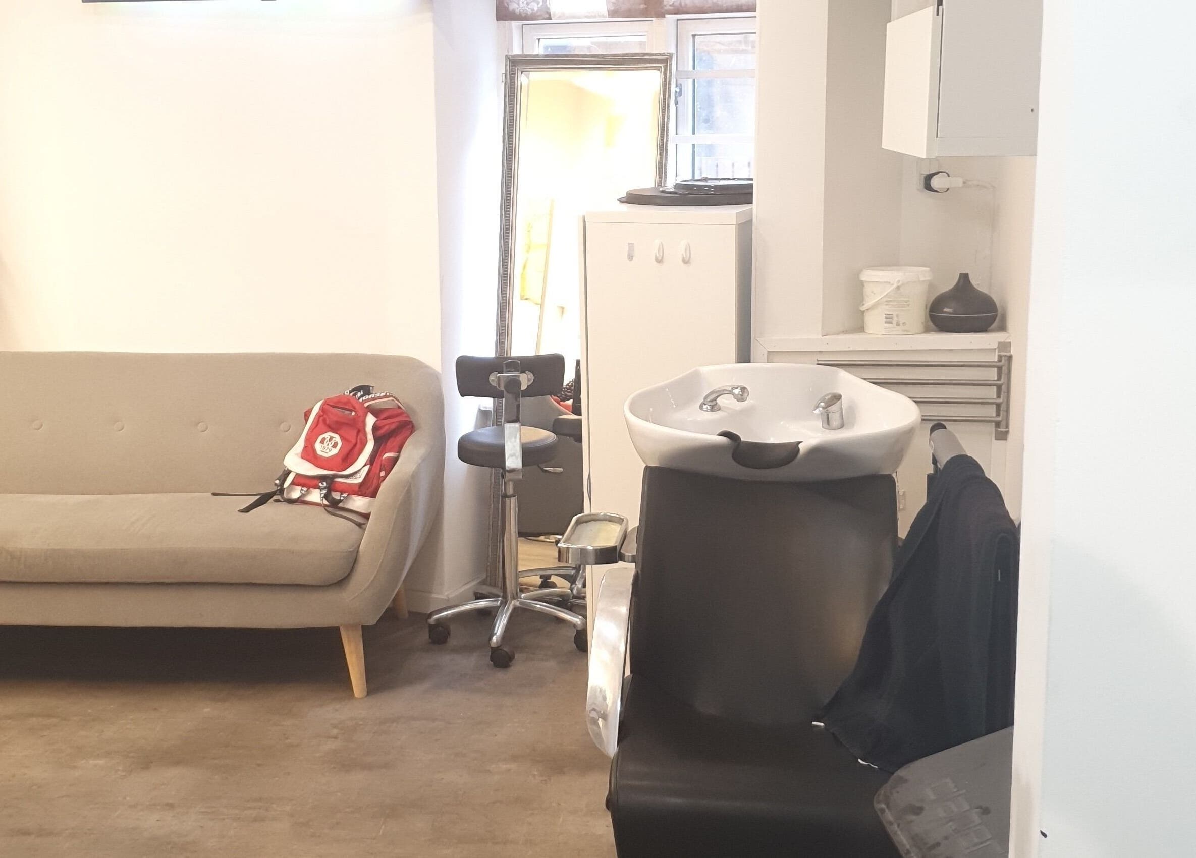 Cozy salon interior at Afrohagen Salon and Kosmetik, Frederiksberg, Denmark, DK with seating and washing station.