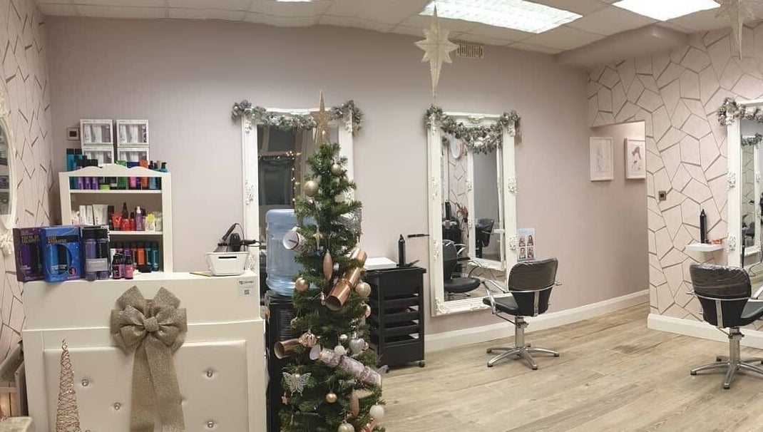 Elegant Cabello salon in Birstall, England, GB adorned with festive decor, mirrors, and styling chairs.