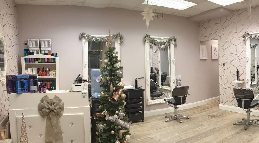 Elegant Cabello salon in Birstall, England, GB adorned with festive decor, mirrors, and styling chairs.