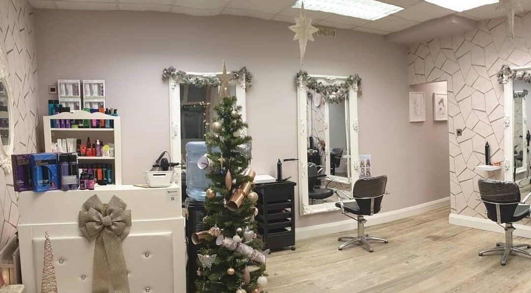 Elegant Cabello salon in Birstall, England, GB adorned with festive decor, mirrors, and styling chairs.