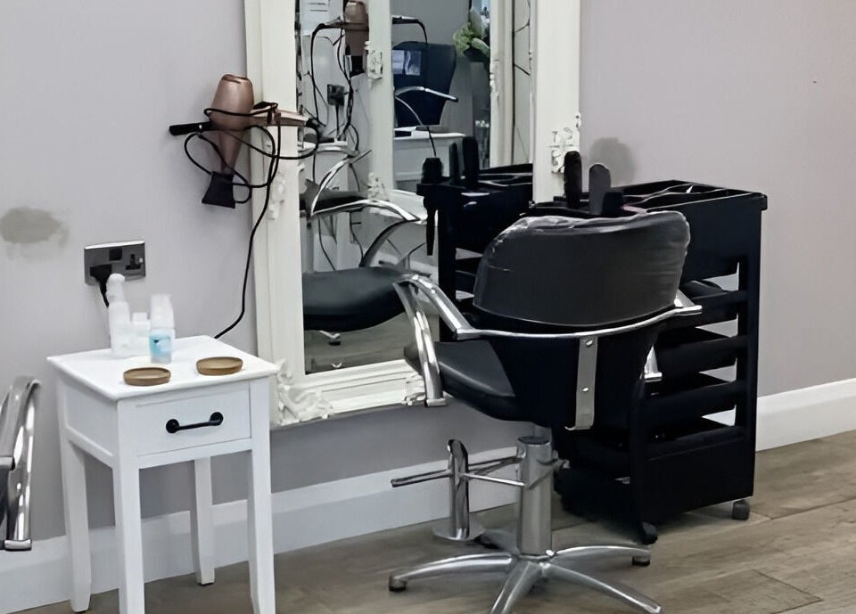 Elegant salon chair and mirror at Cabello in Birstall, England, GB, perfect for luxury hair styling.