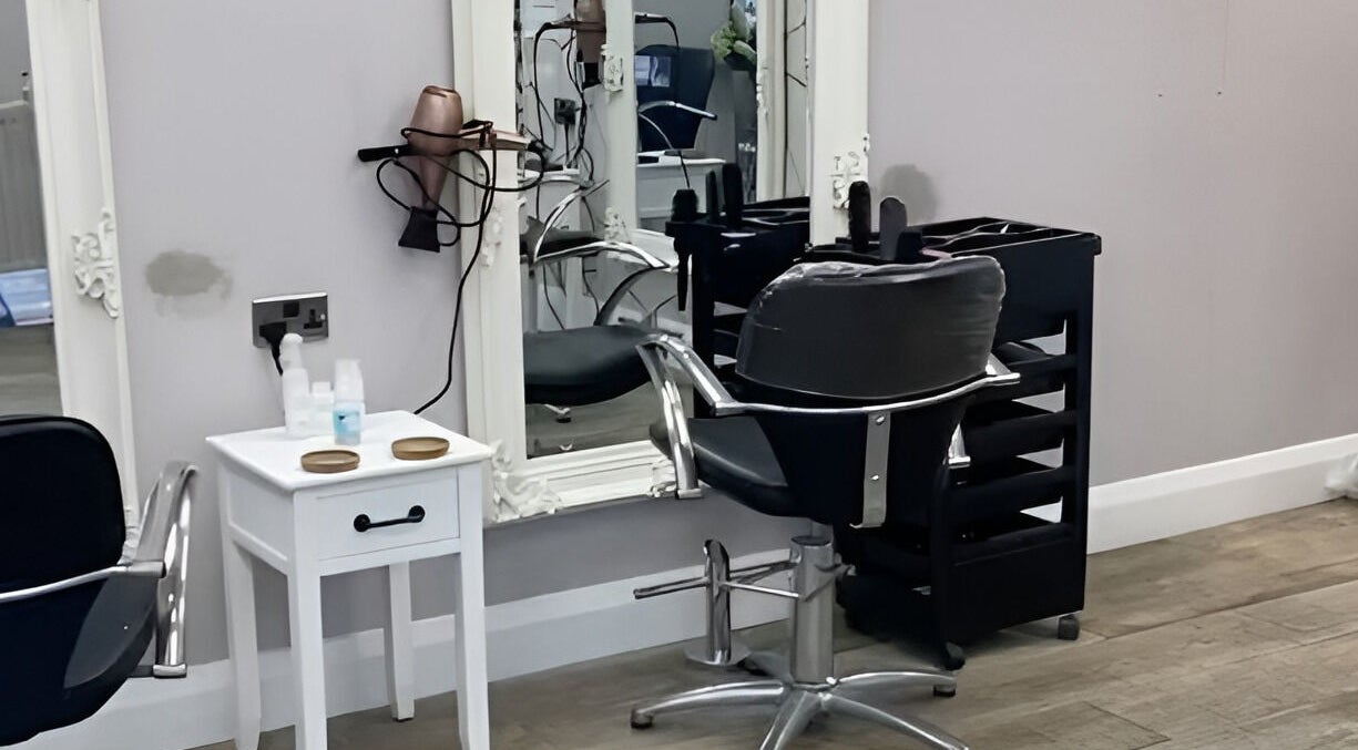 Elegant salon chair and mirror at Cabello in Birstall, England, GB, perfect for luxury hair styling.