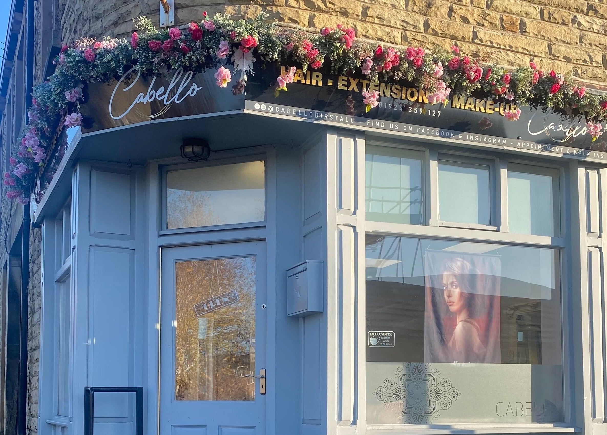 Charming exterior of Cabello in Birstall, England, GB, adorned with floral decorations.
