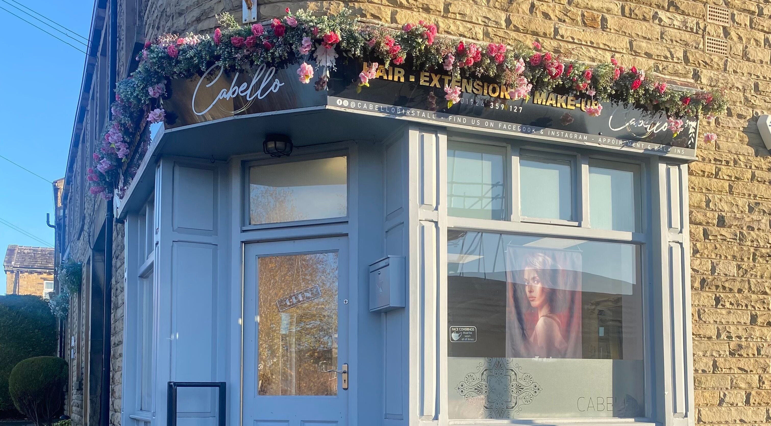Charming exterior of Cabello in Birstall, England, GB, adorned with floral decorations.