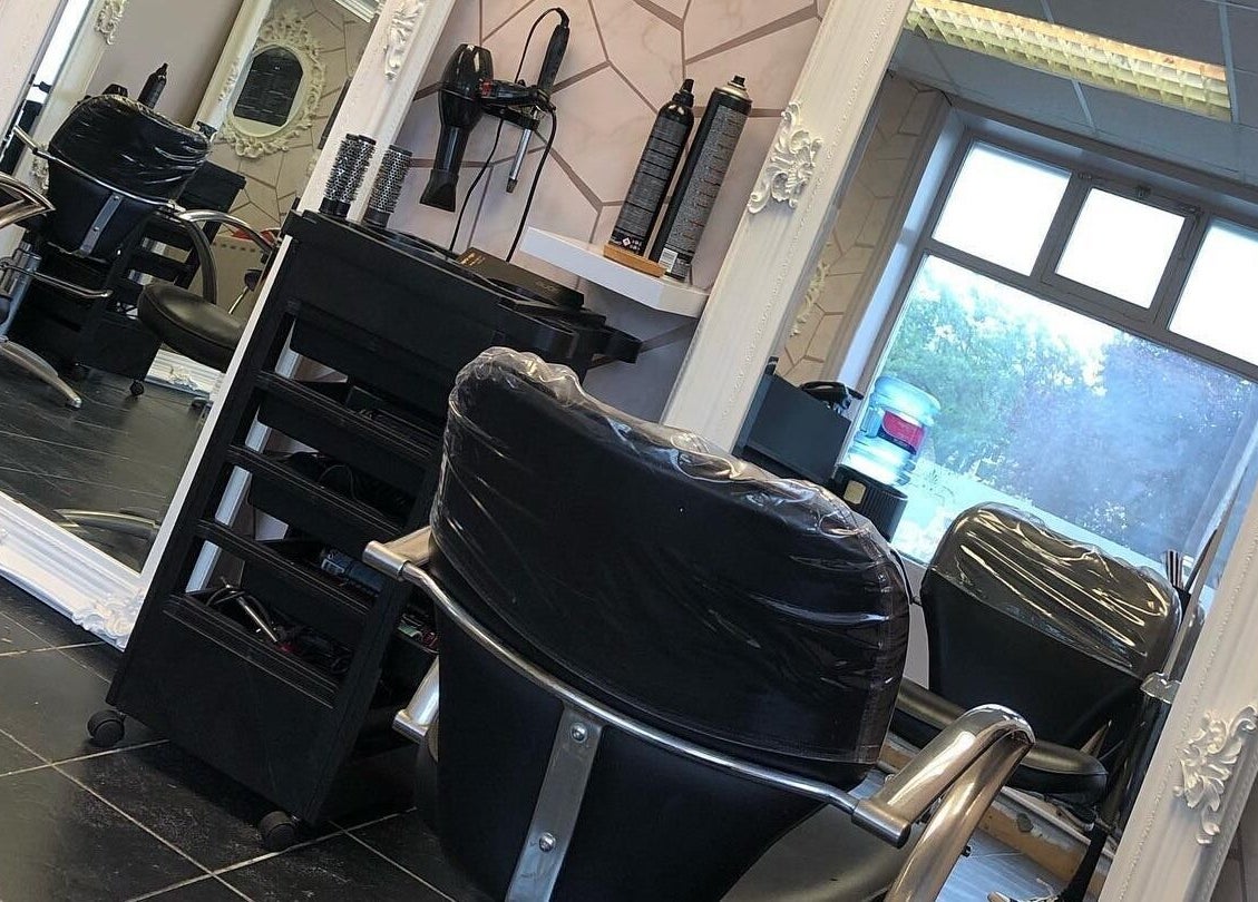 Luxury salon interior at Cabello, Birstall, England, GB, featuring stylish chairs and large mirrors.