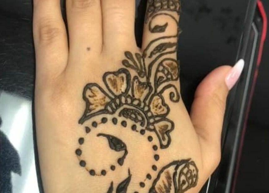 Intricate henna design on hand at Makeover Planet, Poughkeepsie, New York, US enhancing beauty and style.