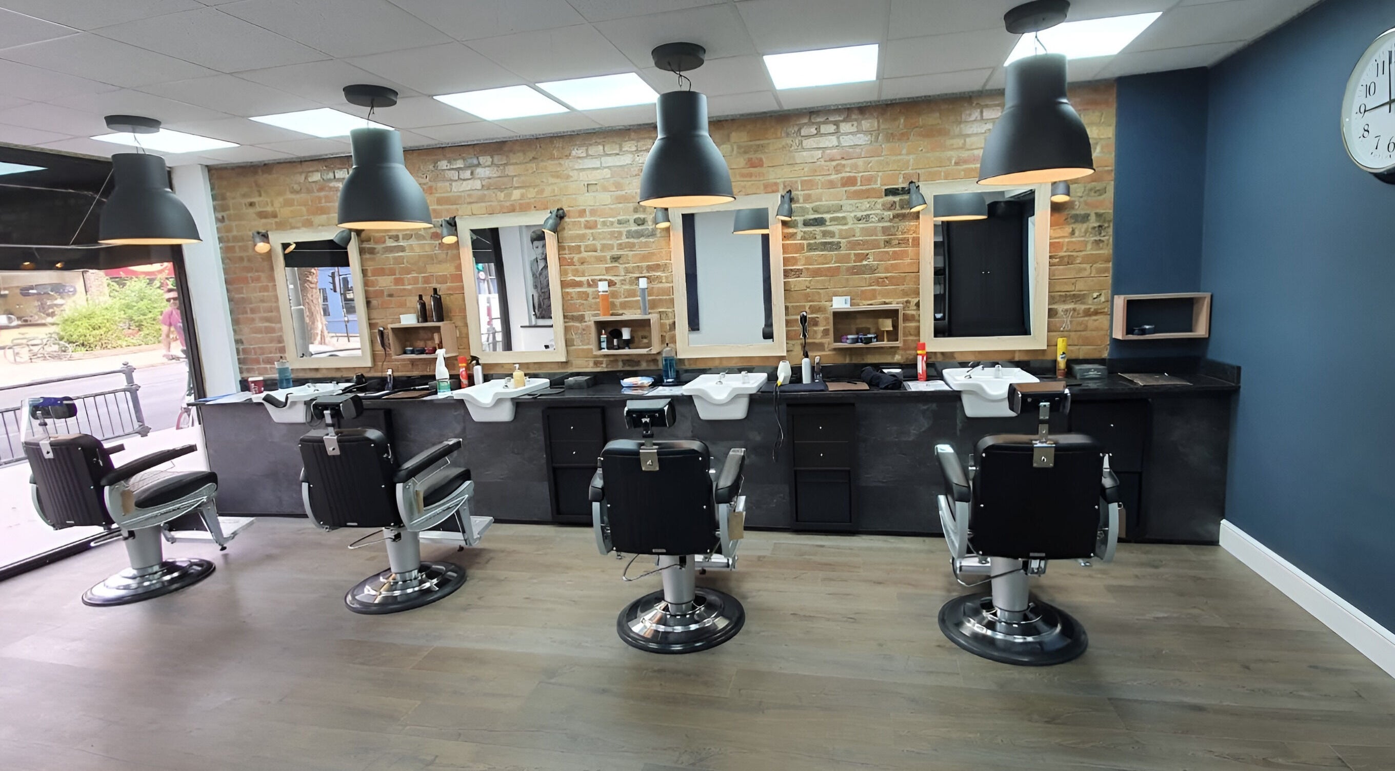 Stylish barber chairs at The Cut East Finchley in London, England, GB with modern decor and bright lighting.