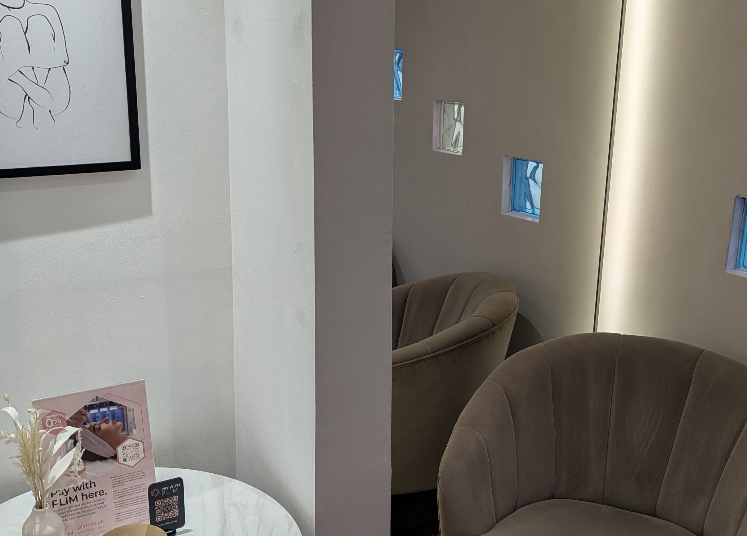 Elegant waiting area with modern art at The Laser Clinic, Halifax, England, GB. Cozy seating enhances relaxation.