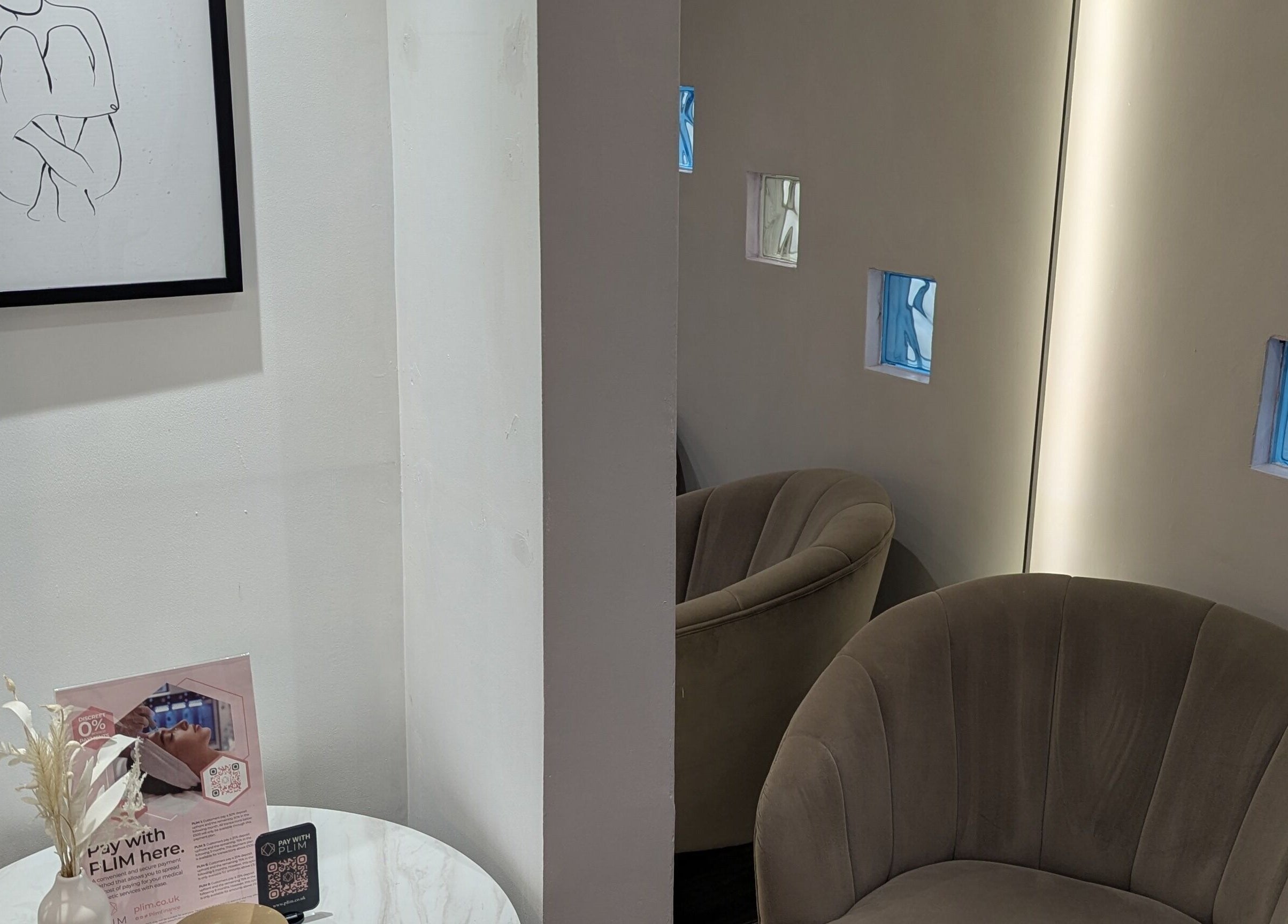 Elegant waiting area with modern art at The Laser Clinic, Halifax, England, GB. Cozy seating enhances relaxation.