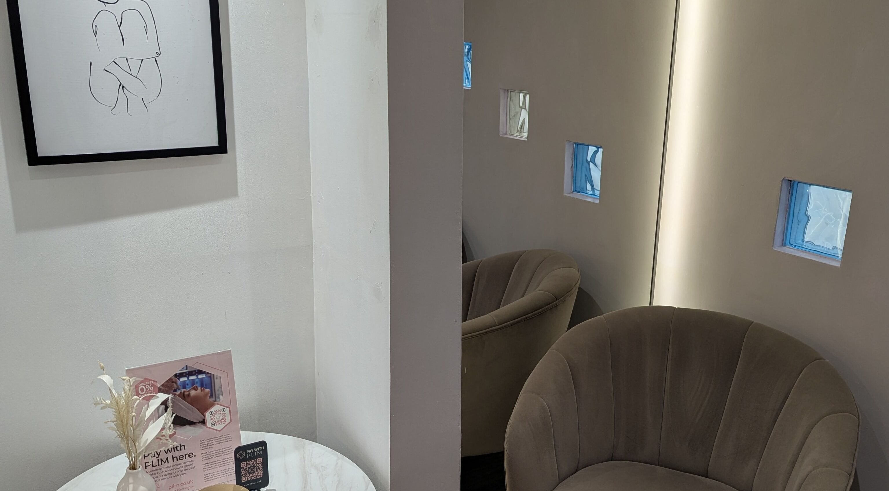 Elegant waiting area with modern art at The Laser Clinic, Halifax, England, GB. Cozy seating enhances relaxation.