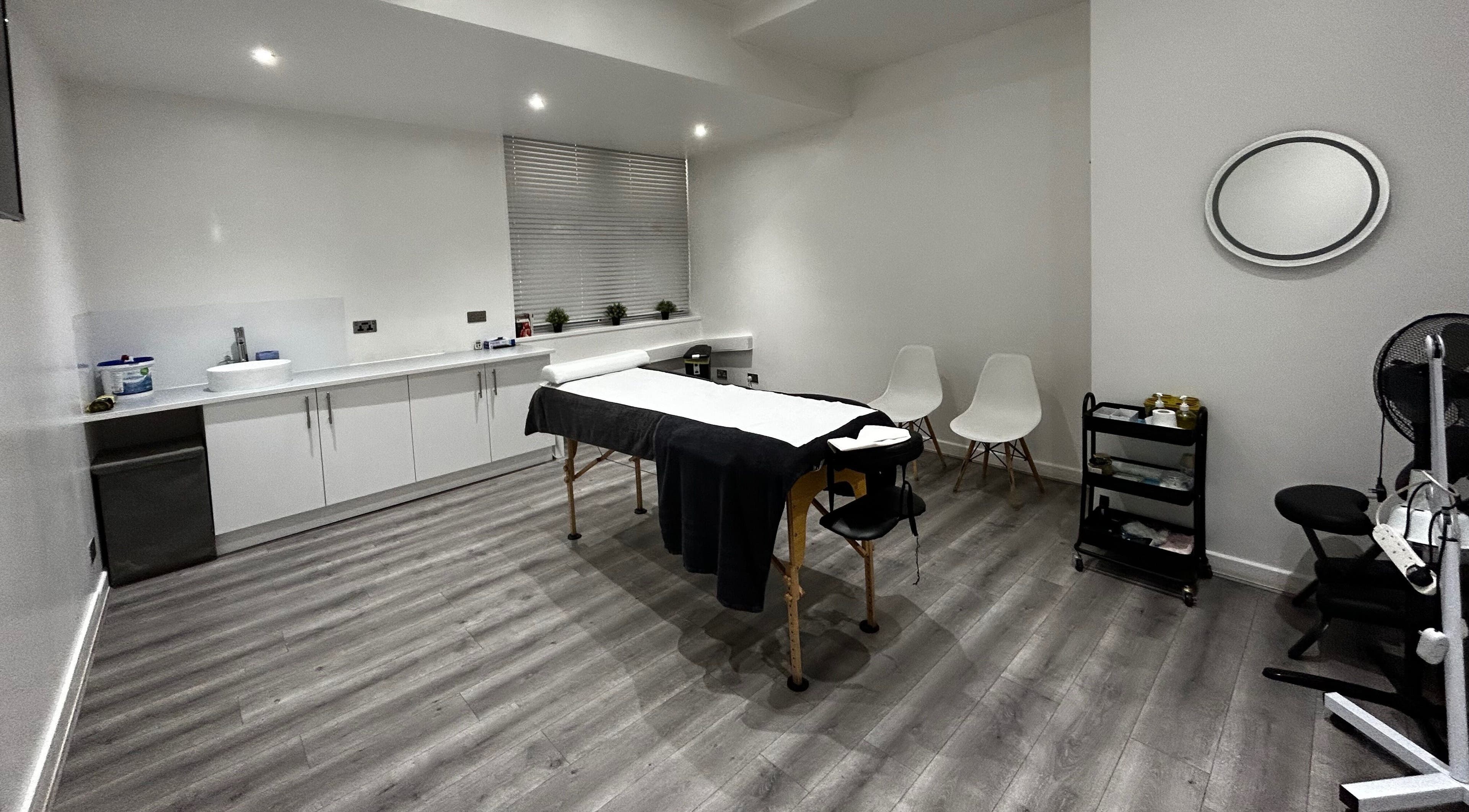 Elegant treatment room at The Cupping Clinic Bolton in Bolton, England, GB featuring a massage table and modern decor.