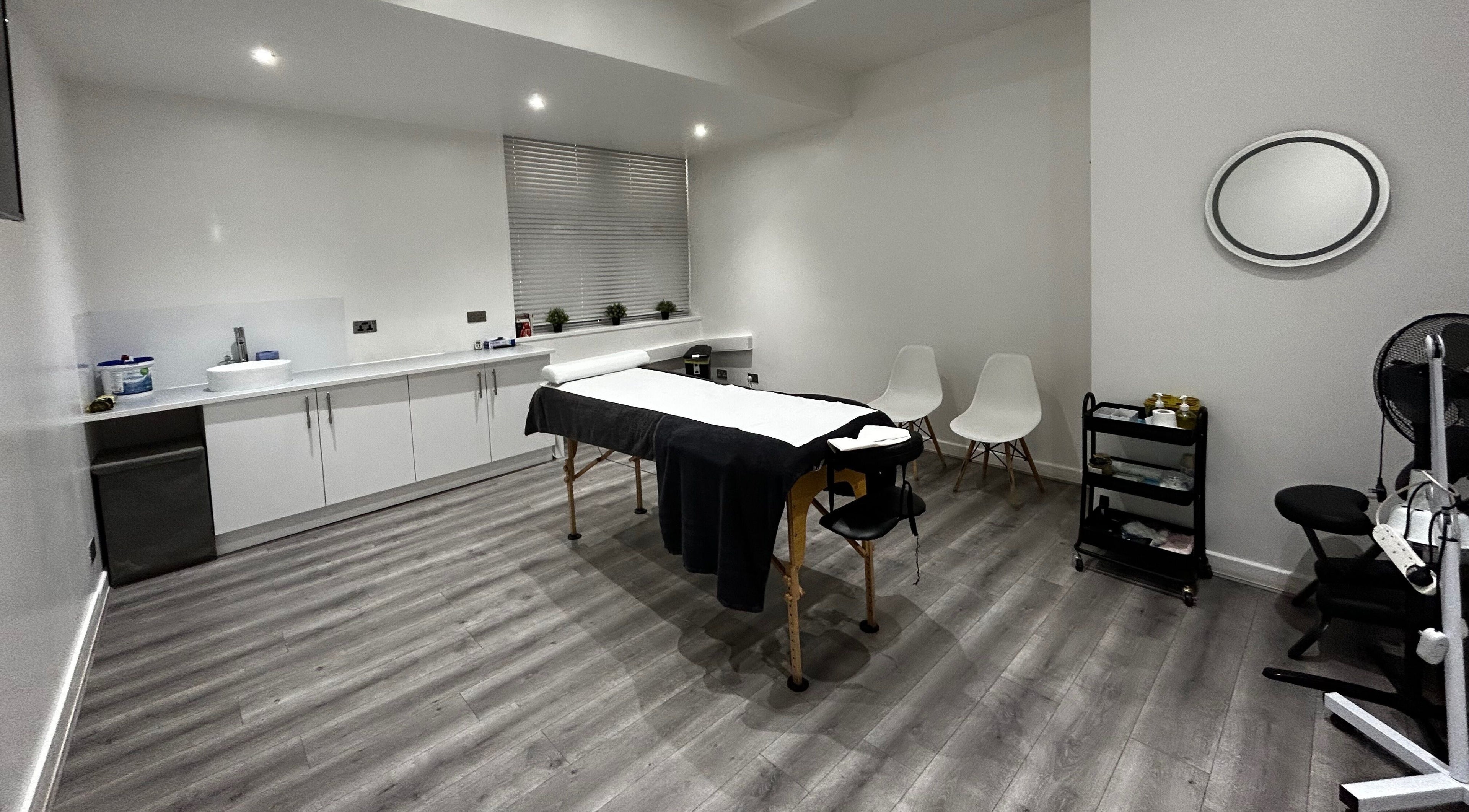Elegant treatment room at The Cupping Clinic Bolton in Bolton, England, GB featuring a massage table and modern decor.