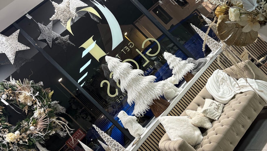 Festive decor at Get The Gloss, Hamilton, Scotland, GB. Elegant white trees and wreaths adorn the cozy interior.