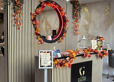 Lobby of Get The Gloss in Hamilton, Scotland, GB, adorned with autumn leaves and chic decor.