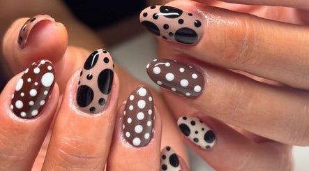 Stylish polka dot nail art at Get The Gloss in Hamilton, Scotland, GB enhances chic and trendy nail styles.