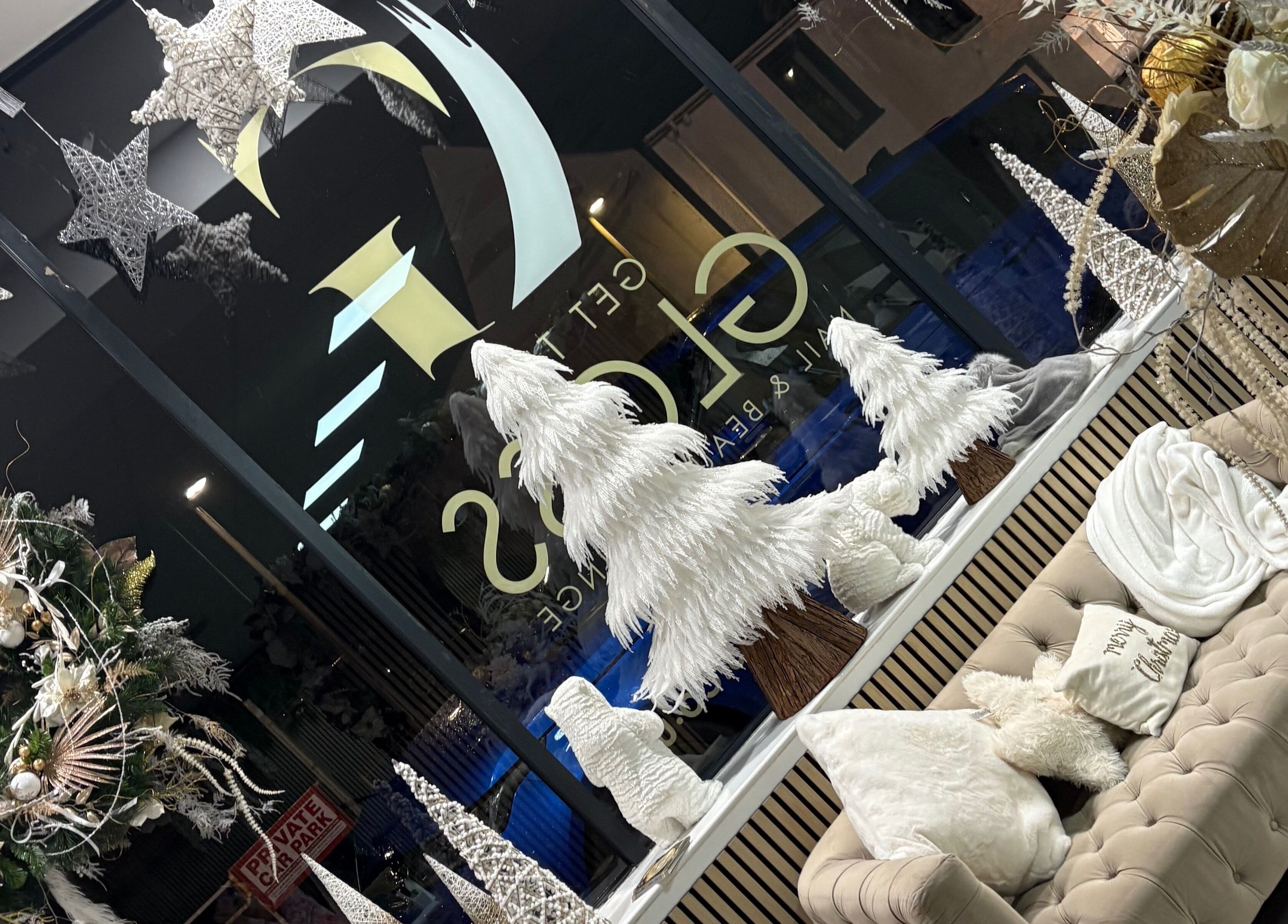 Cozy winter lounge at Get The Gloss, Hamilton, Scotland, GB, with festive decor and comfy seating.