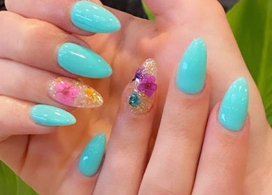 Elegant aqua nails with floral designs at Champagne Nail Bar in Santa Barbara, California, US.