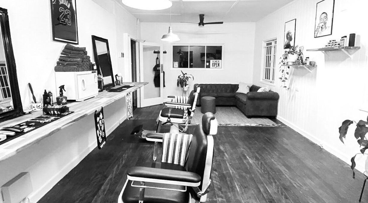 Stylish interior of The Notorious Barbershop, Banyo, Queensland, AU with vintage chairs and modern decor.