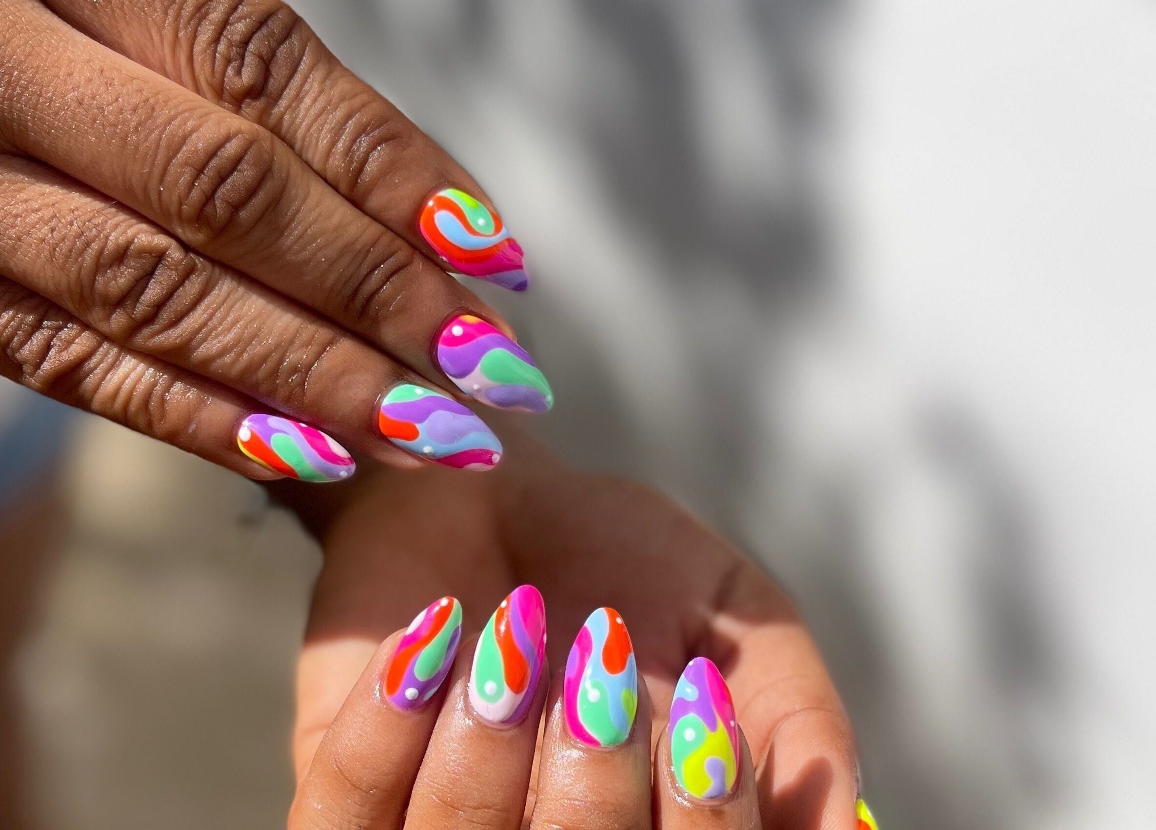 Vibrant rainbow nail art at Slay By Daè, St. James, BB, showcasing detailed multicolor design.