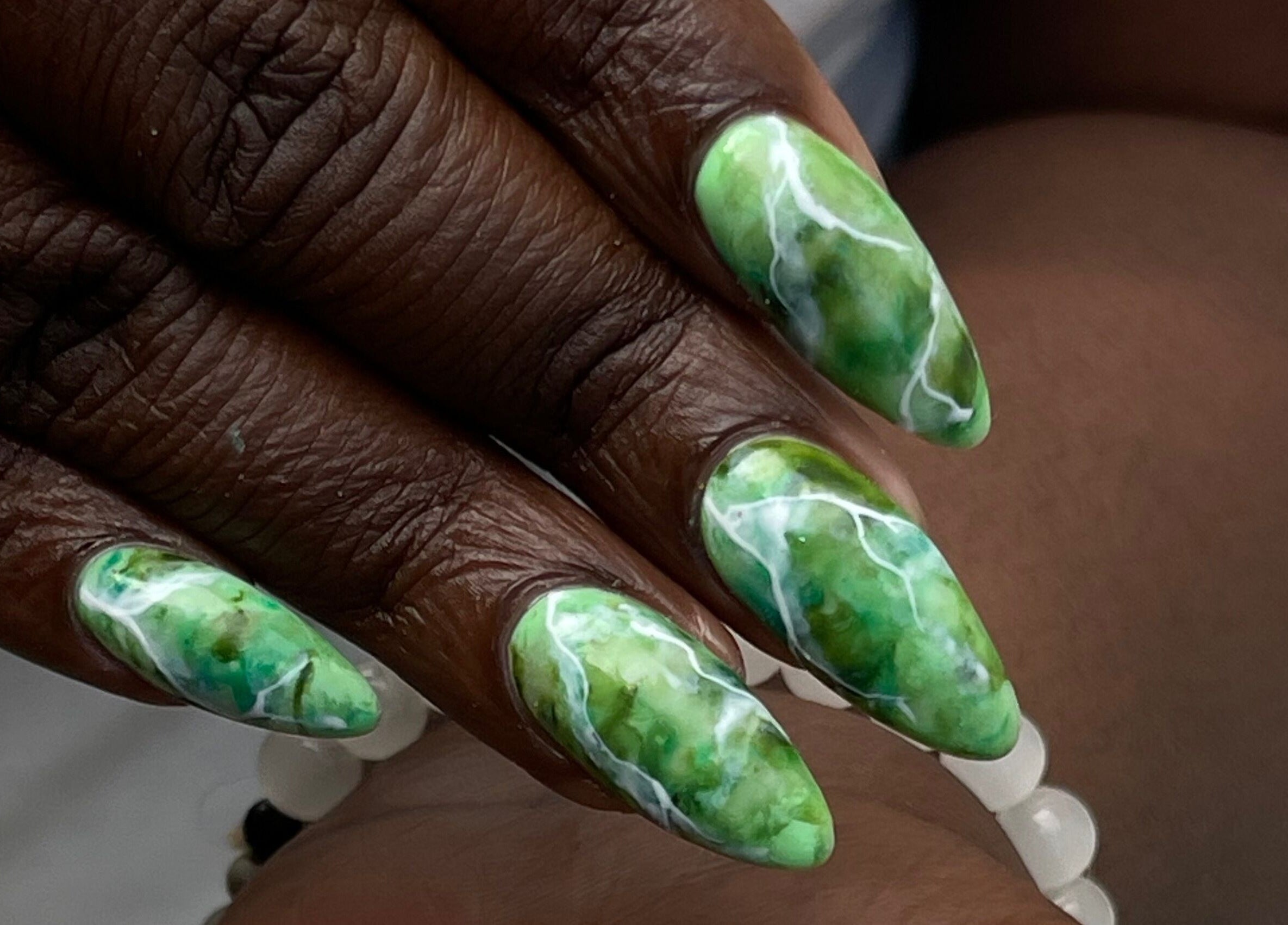 Green marble nail art by Slay By Daè, St. James, BB. Stunning and intricate design.