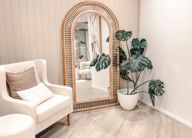 Cozy seating with mirror and plant at Zovia Beauty in Griffith, Australian Capital Territory, AU.