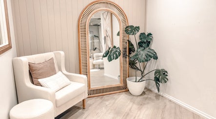 Cozy seating with mirror and plant at Zovia Beauty in Griffith, Australian Capital Territory, AU.