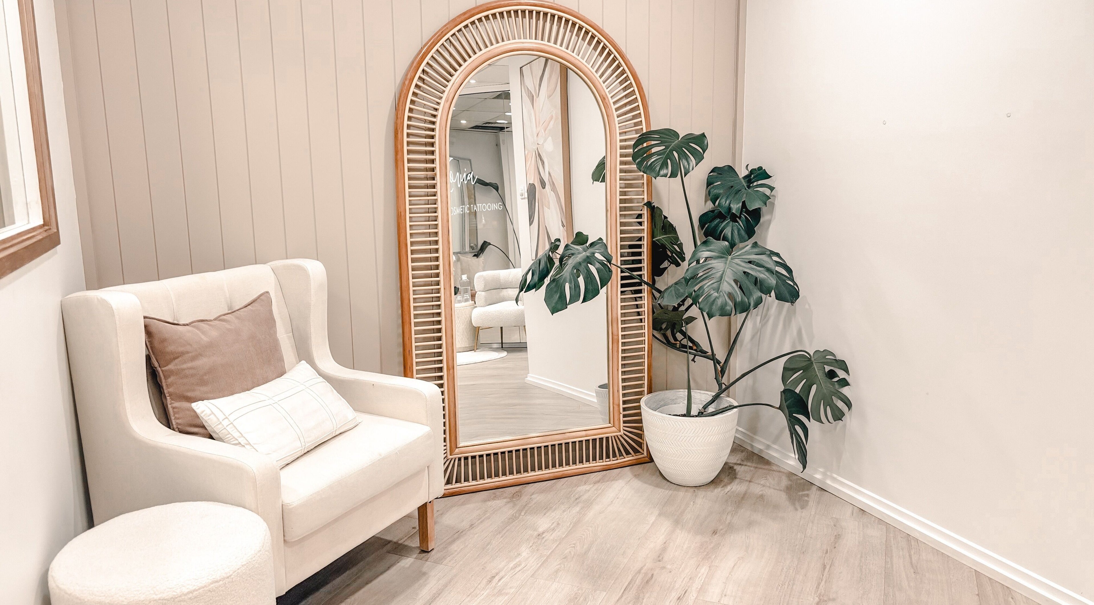 Elegant corner in Zovia Beauty, Griffith, ACT with armchair, mirror, and plant for a relaxing ambiance.