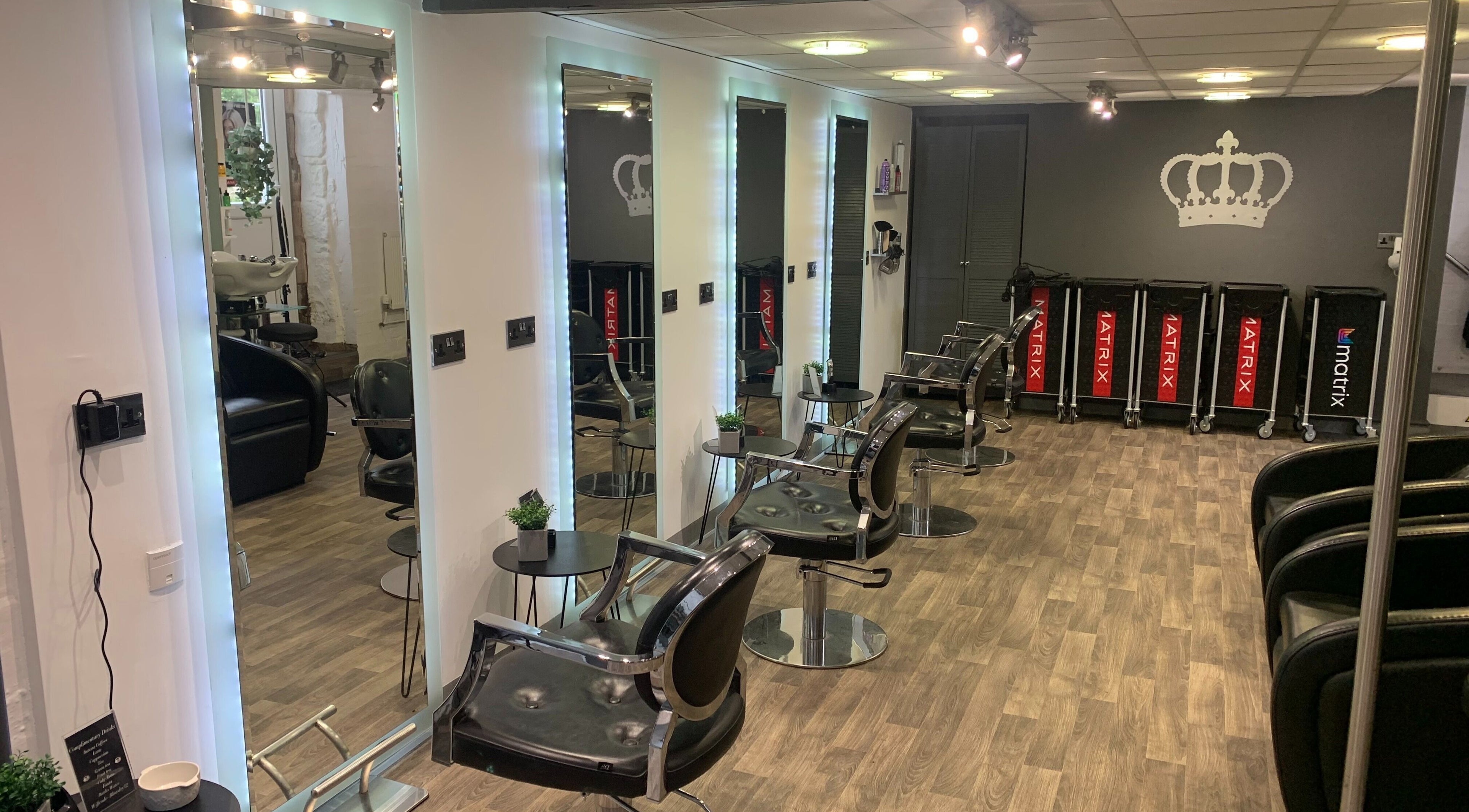 Modern salon interior at King's Hair Studio in Carlisle, England, GB, featuring sleek styling chairs and mirrors.