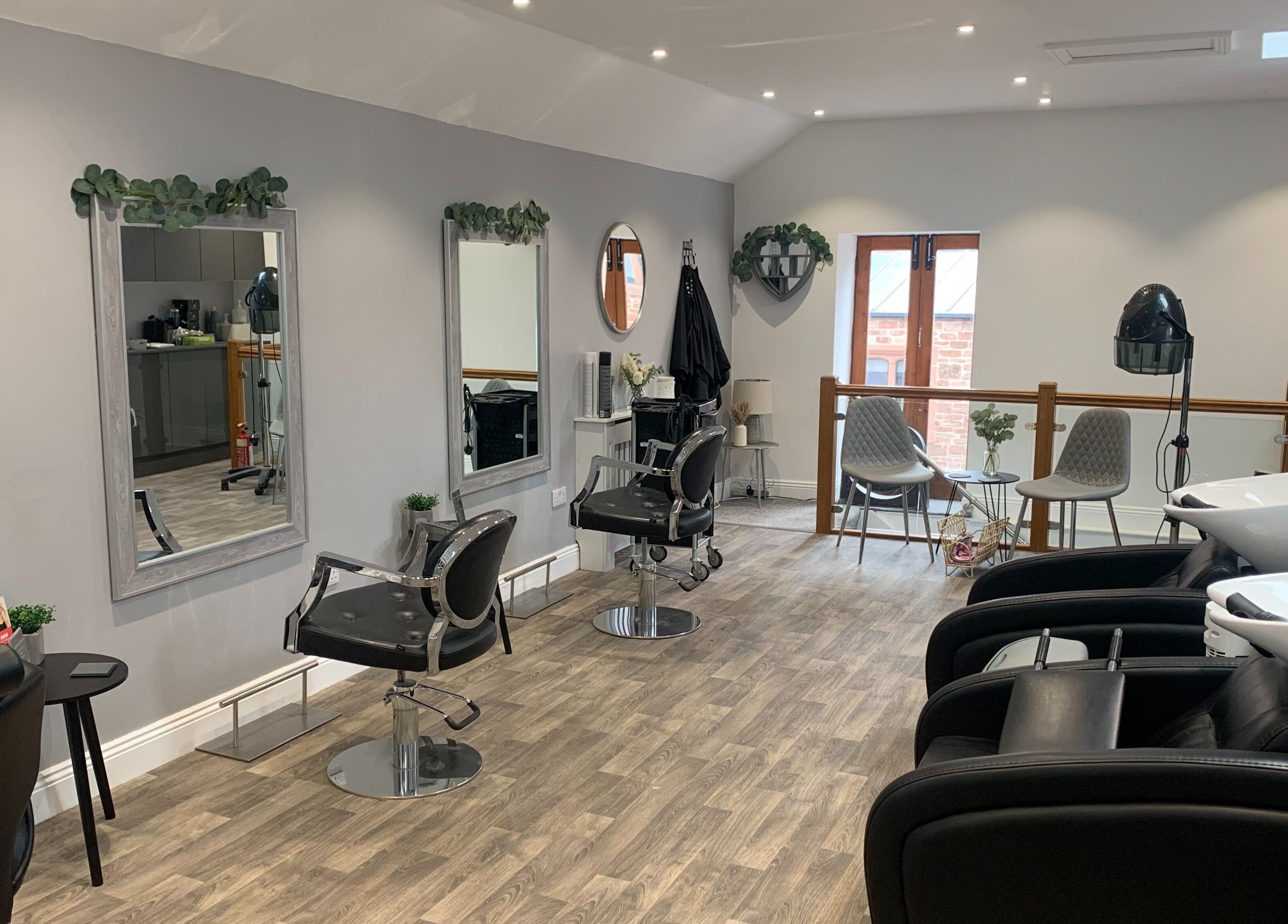 Modern salon interior at King's Hair Studio in Carlisle, England. Spacious with sleek chairs and stylish decor.