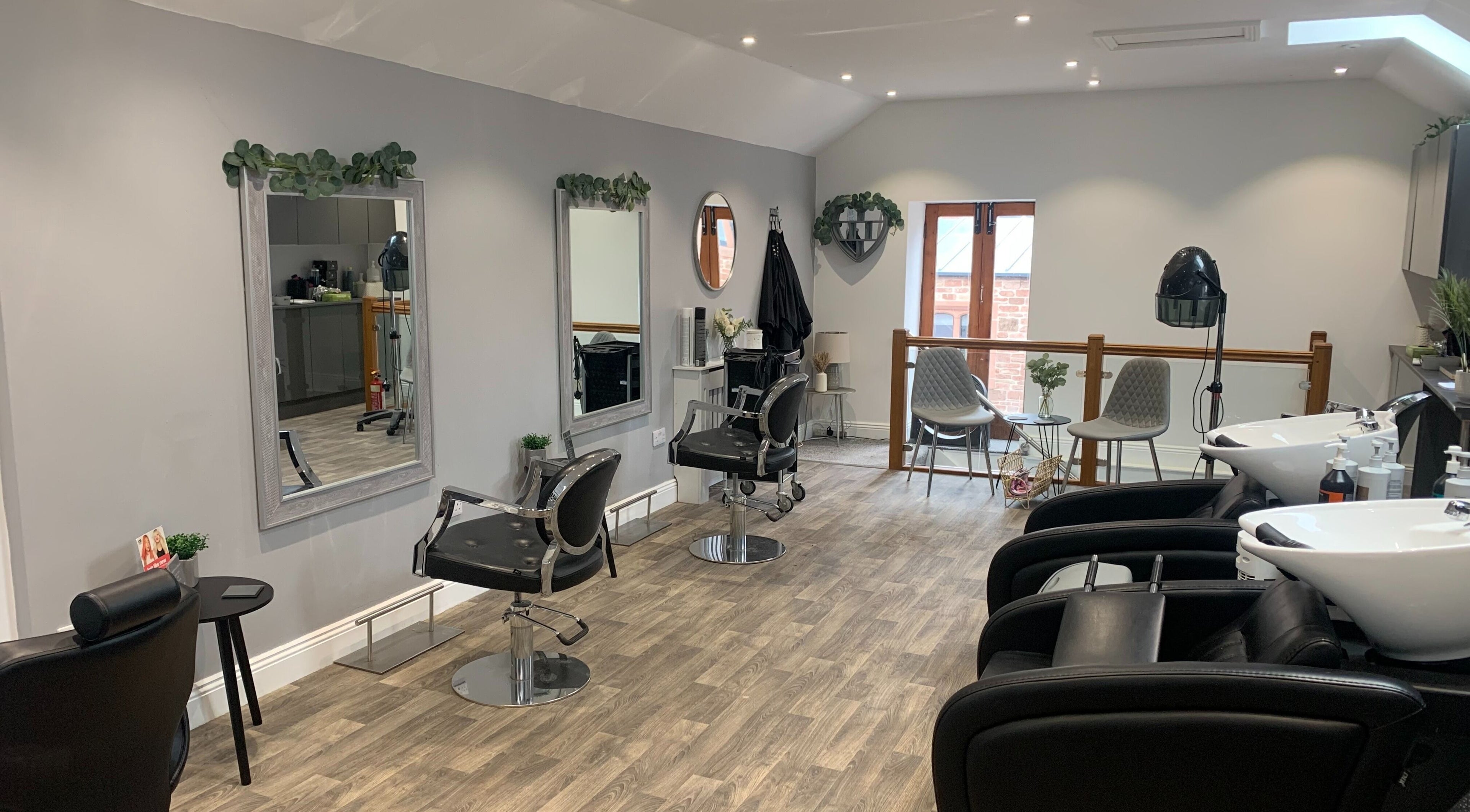 Modern salon interior at King's Hair Studio in Carlisle, England. Spacious with sleek chairs and stylish decor.